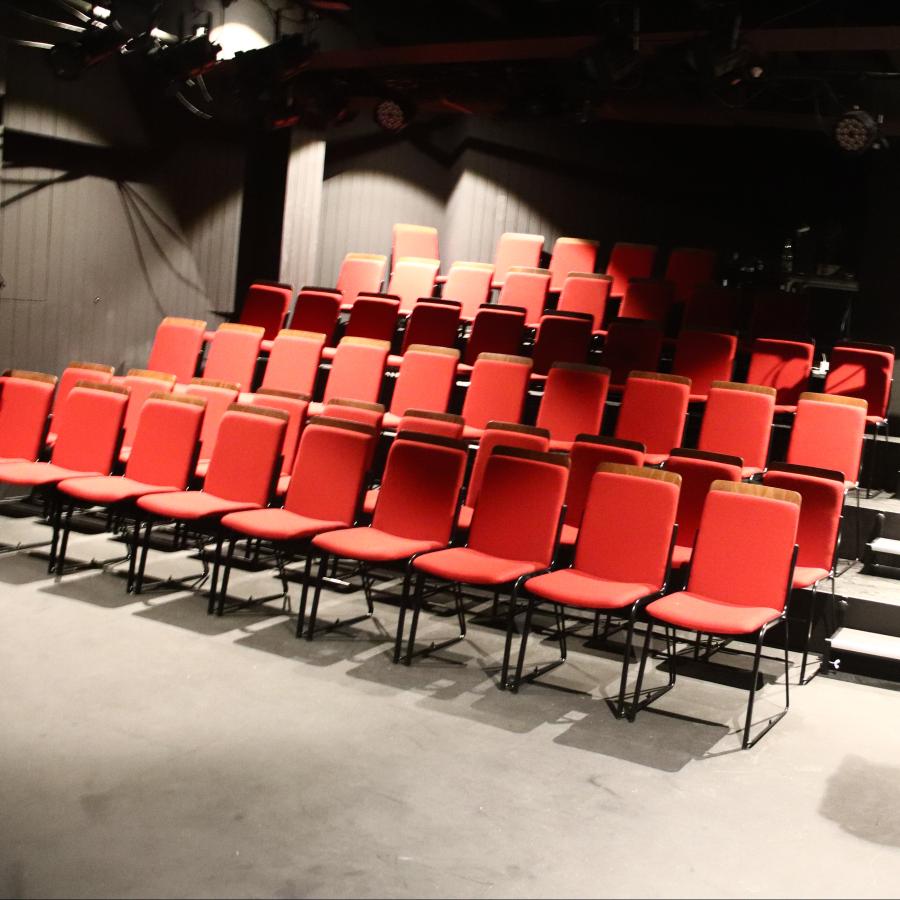 a photo of red seating bank in the theatre 
