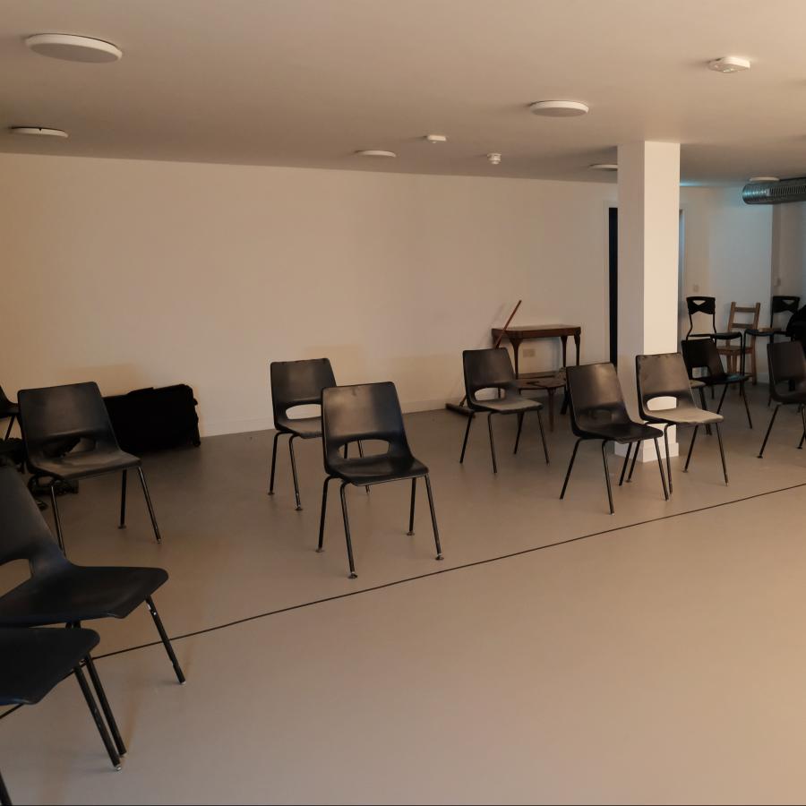 Basement space set up with socially distanced seating 
