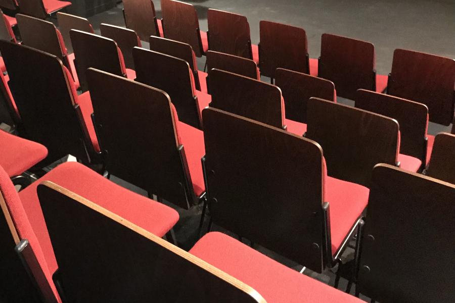 Red chairs in a black box theatre