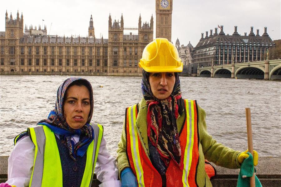 Two people in high viz jackets standing in front of the river and Big Ben
