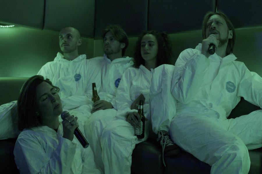 Photo of ClusterFlux dressed as astronauts in a karaoke booth