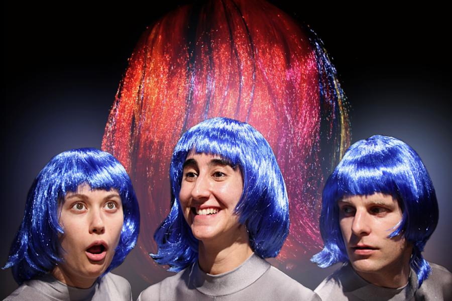 3 people wearing grey shirts and purple wigs smile, gasp and glare at each other with a background of an orange wig