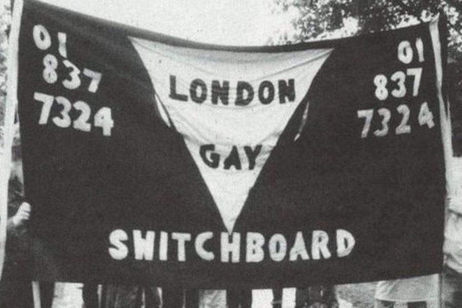 Black and white banner reading 'London Gay Switchboard' and the number '01-837-7324' on each side.