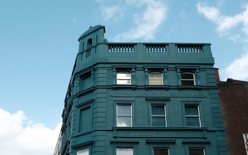 Camden People's Theatre building pictured from the outside with teal walls and big windows.