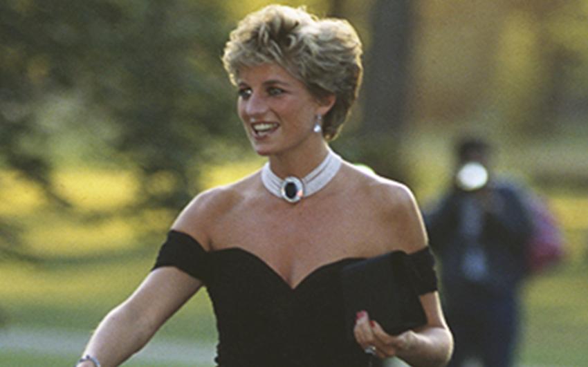 Diana Spencer wears a chic black dress, famously referred to as the 'Revenge Dress'.