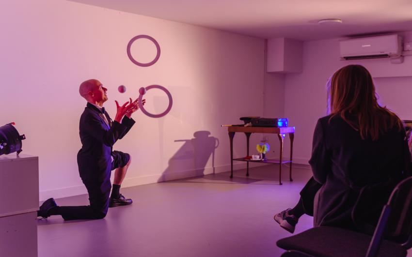 A person juggling hoops and rings in a performance in the CPT basement space